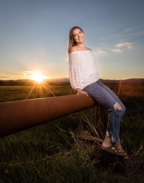 Senior portrait taken at sunset at the edge of the field by Blue Ridge Expressions